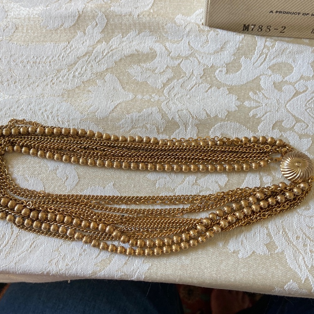 Vintage gold tone multi strand necklace. 16”. Fluted beads and chaining